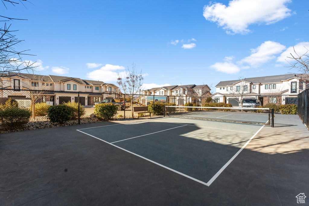 View of tennis court featuring a residential view