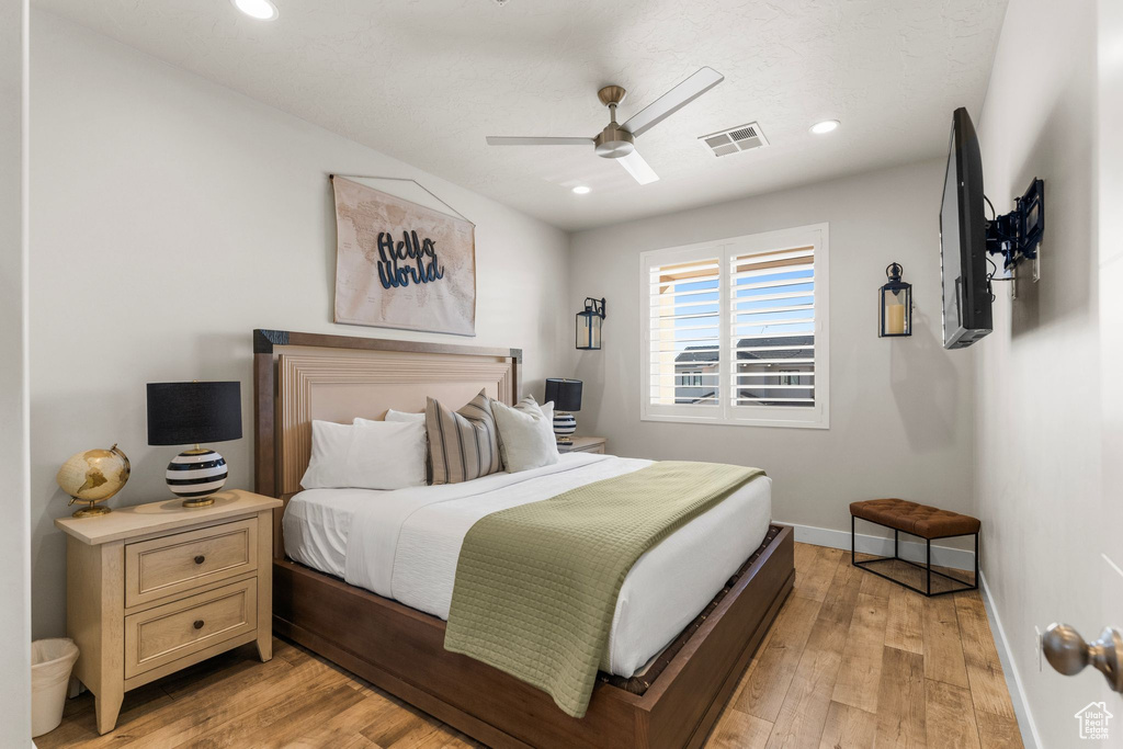 Bedroom featuring baseboards, light wood-style flooring, recessed lighting, and a ceiling fan