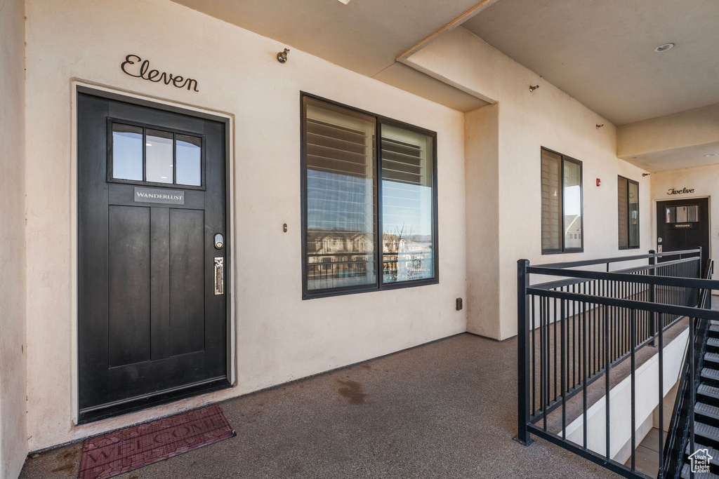 Doorway to property featuring stucco siding