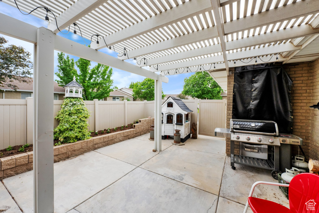 Fenced backyard with a patio and area for grilling