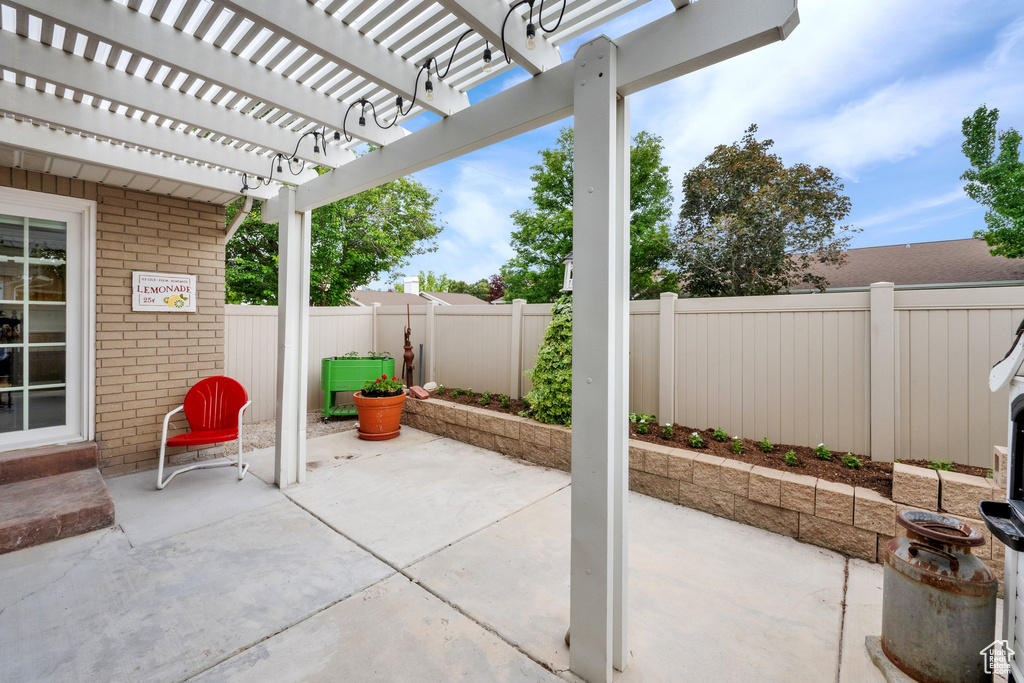 Fenced backyard featuring a patio and a pergola