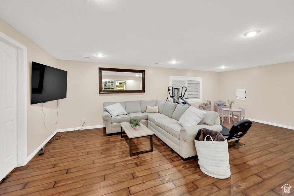 Living area with wood-type flooring, recessed lighting, and baseboards