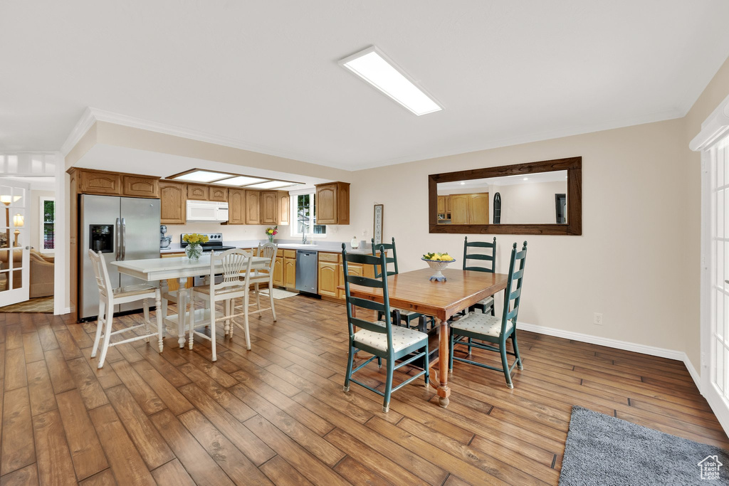 Dining room featuring light wood finished floors and baseboards