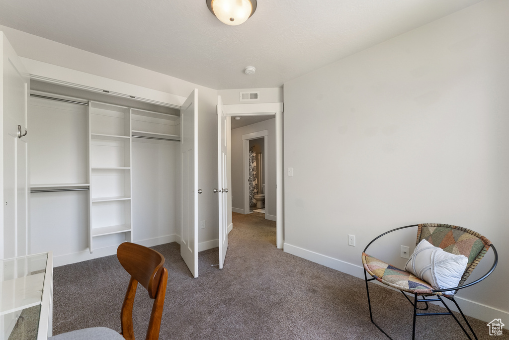 Bedroom featuring carpet flooring, baseboards, and a closet