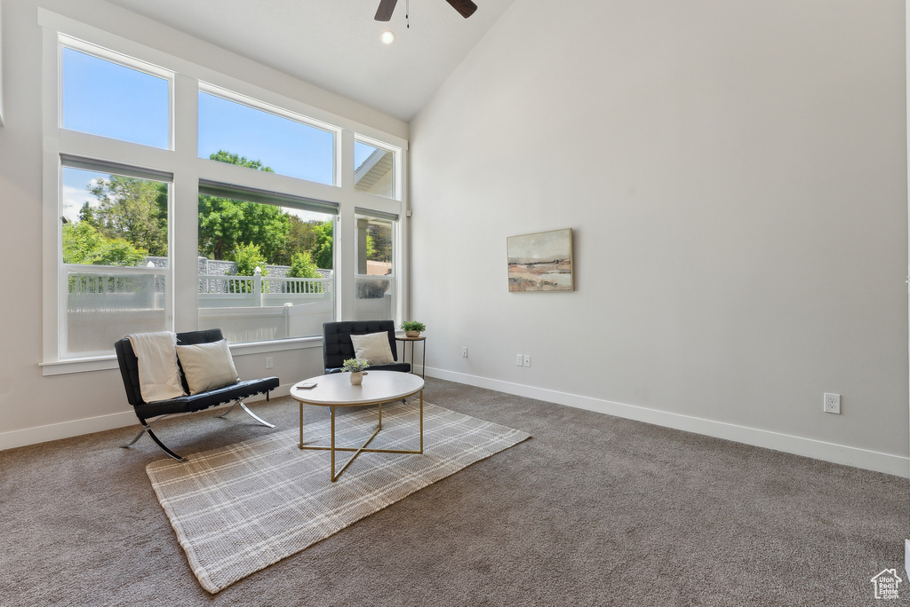 Sitting room featuring high vaulted ceiling, a ceiling fan, carpet, and baseboards