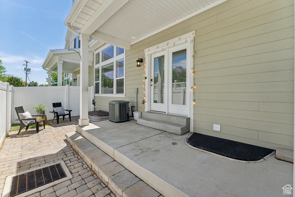 Property entrance with central AC and a patio area