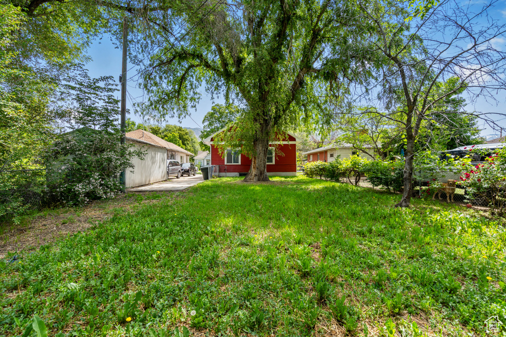 View of green lawn with a patio area