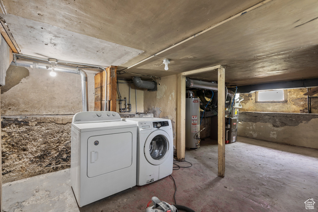 Basement with gas water heater, separate washer and dryer, and heating unit
