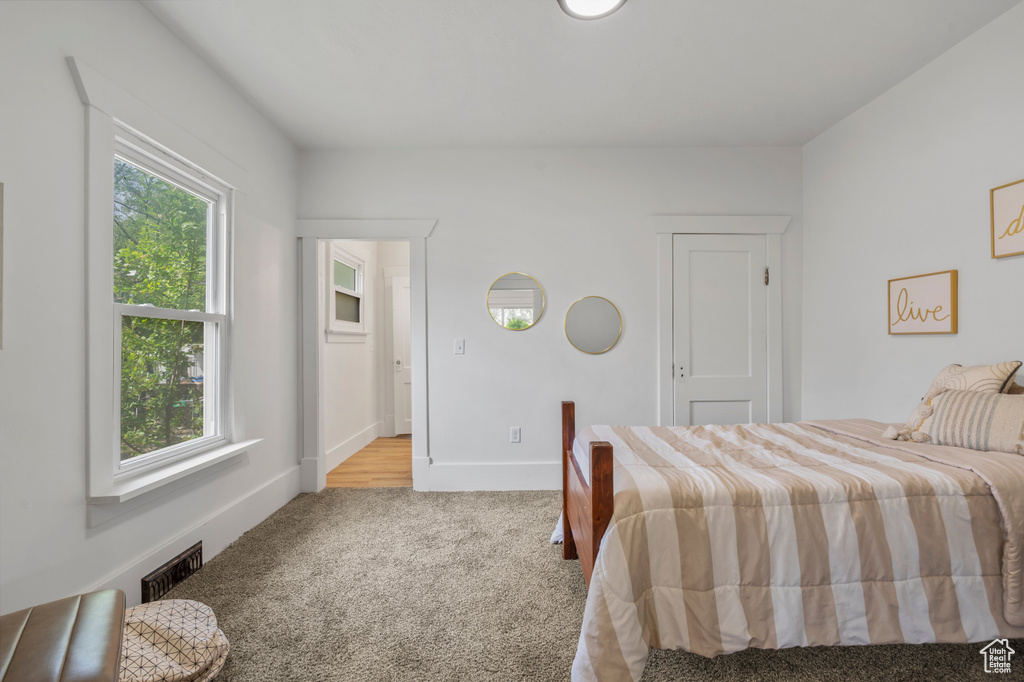 Bedroom featuring carpet and baseboards