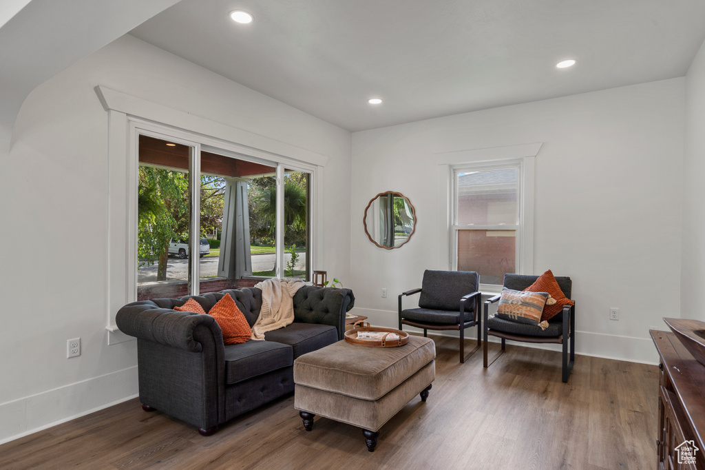 Living area with wood finished floors, baseboards, and recessed lighting