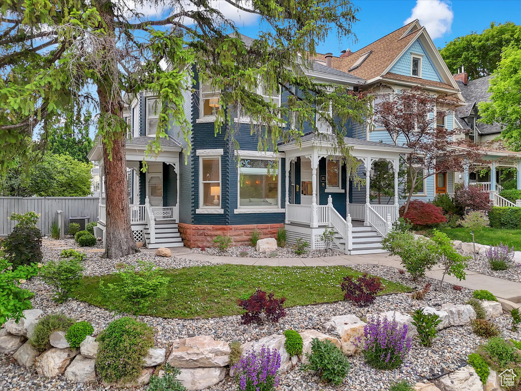 View of front of house featuring a porch and a shingled roof