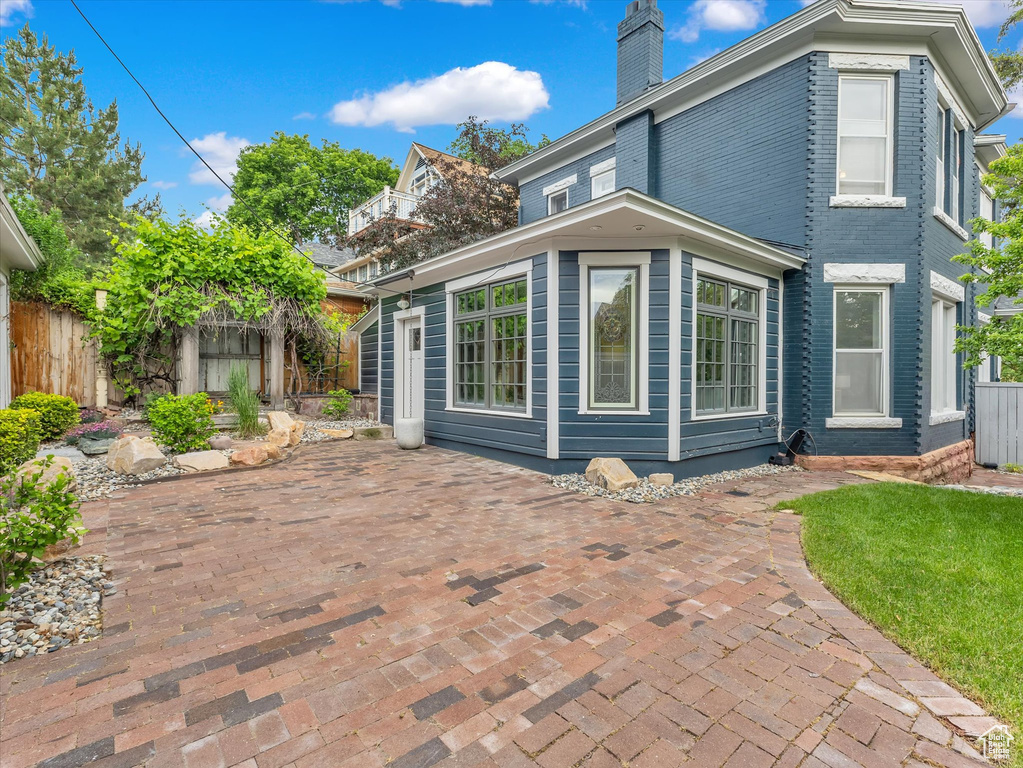 View of home\\\\\\\'s exterior with a chimney and a patio