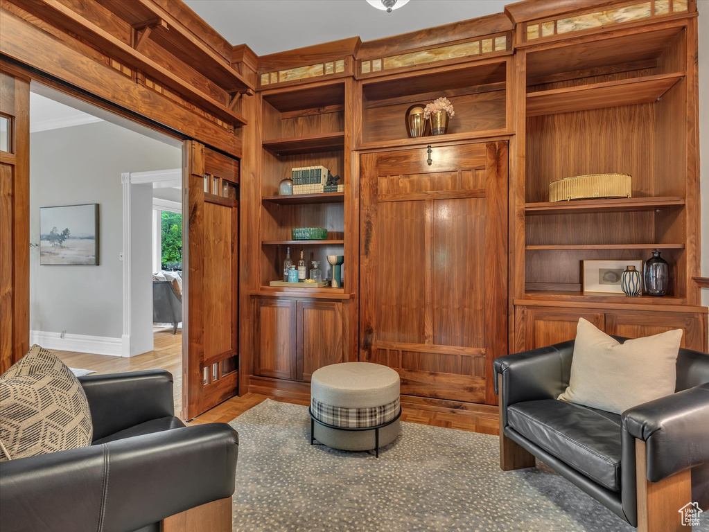 Living area featuring built in features, wood finished floors, and baseboards