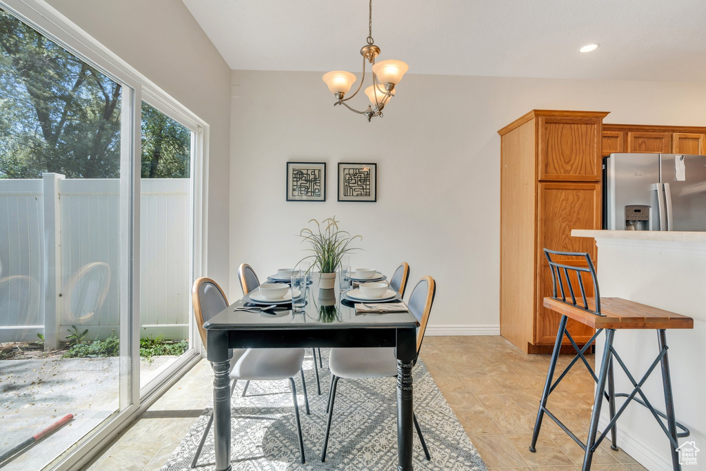 Dining space with a chandelier, recessed lighting, and baseboards