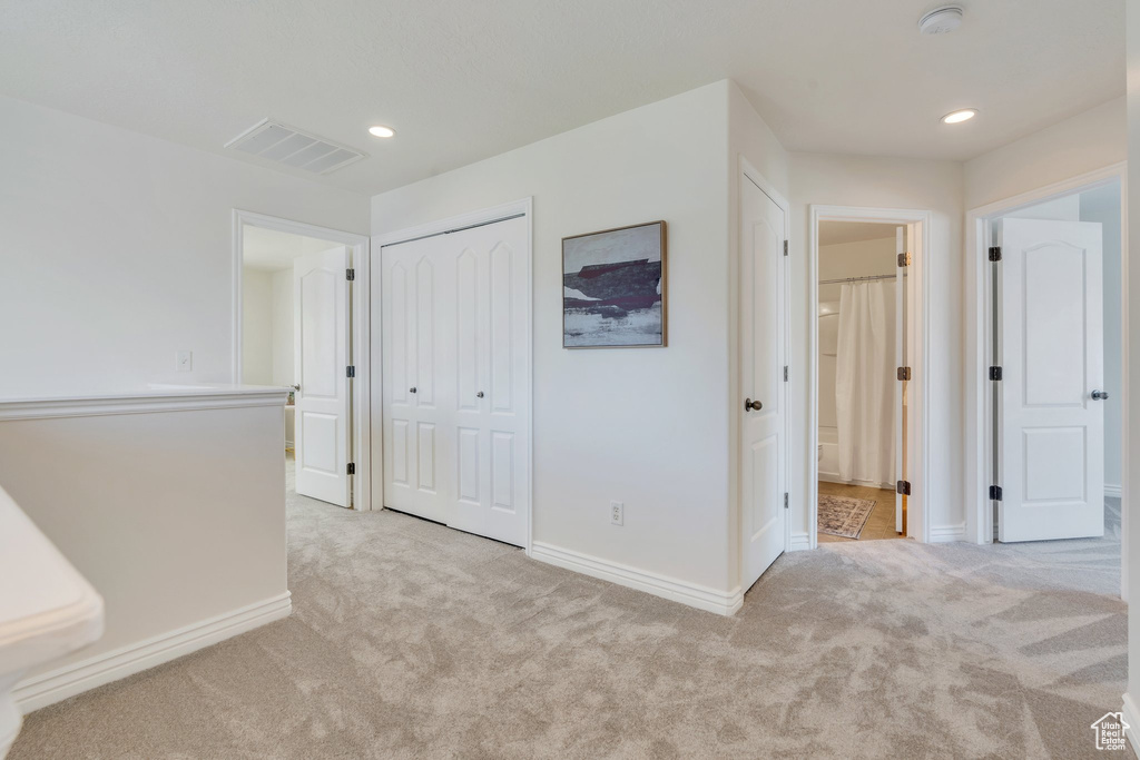 Hallway with carpet floors, baseboards, and recessed lighting