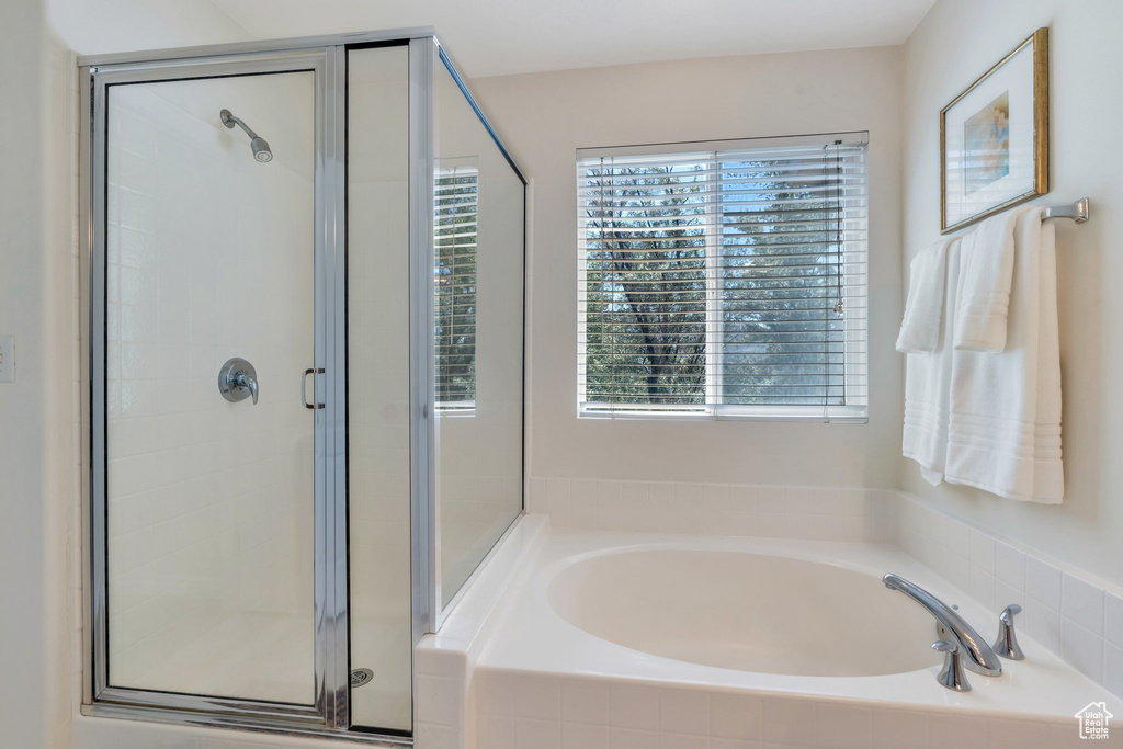 Bathroom featuring a shower stall and a garden tub