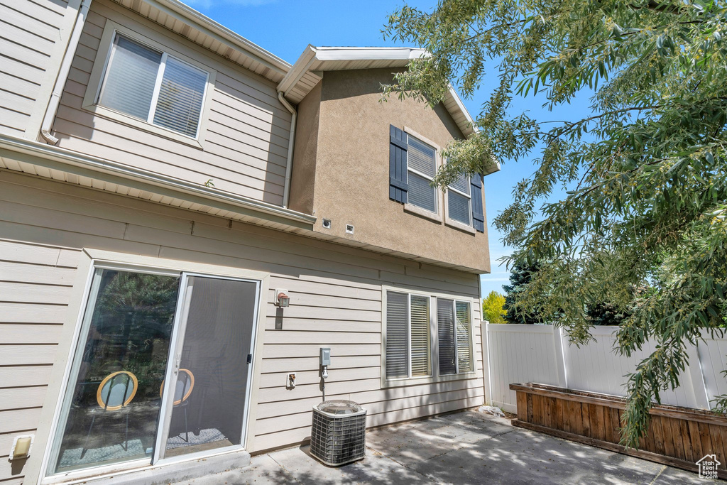 Back of house featuring a patio area and central AC