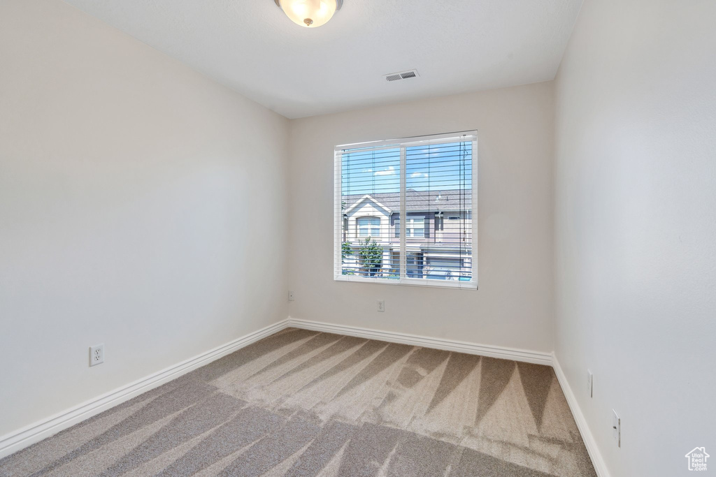 Empty room featuring carpet floors and baseboards