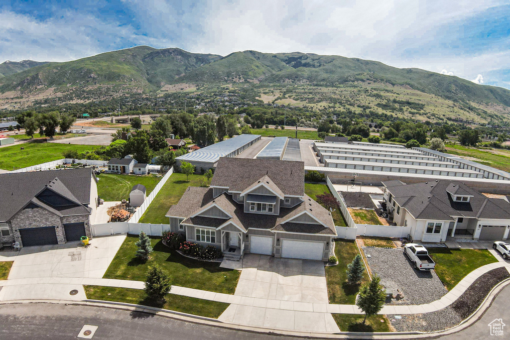 Aerial view of property and surrounding area featuring a mountain backdrop