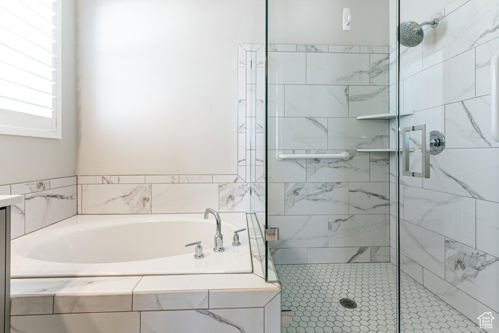 Full bath featuring a bath and a stall shower