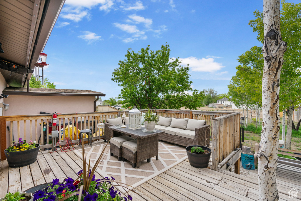 Wooden terrace featuring an outdoor hangout area