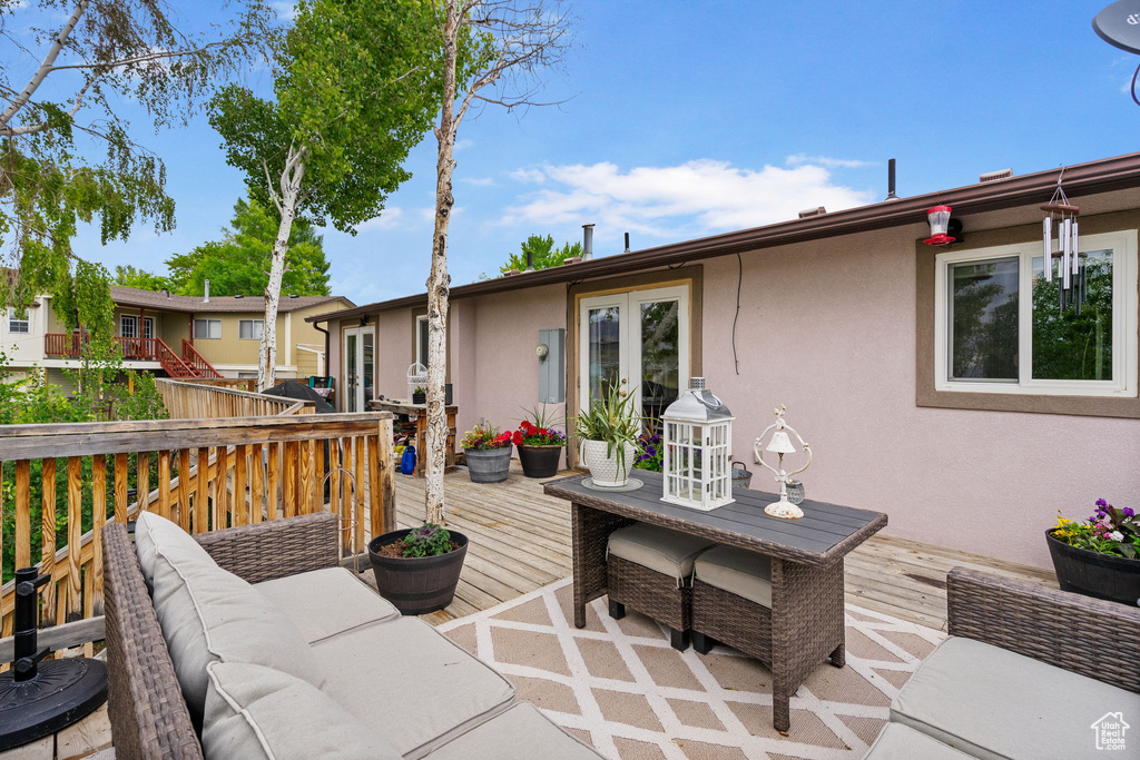 Deck featuring an outdoor living space and french doors