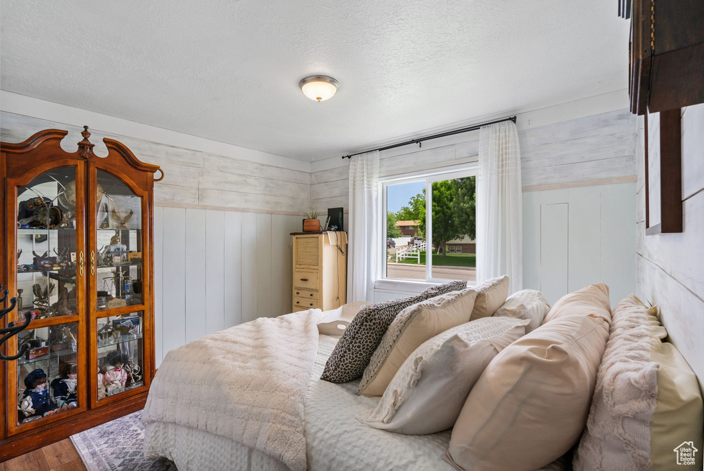 Bedroom featuring wood finished floors and a textured ceiling
