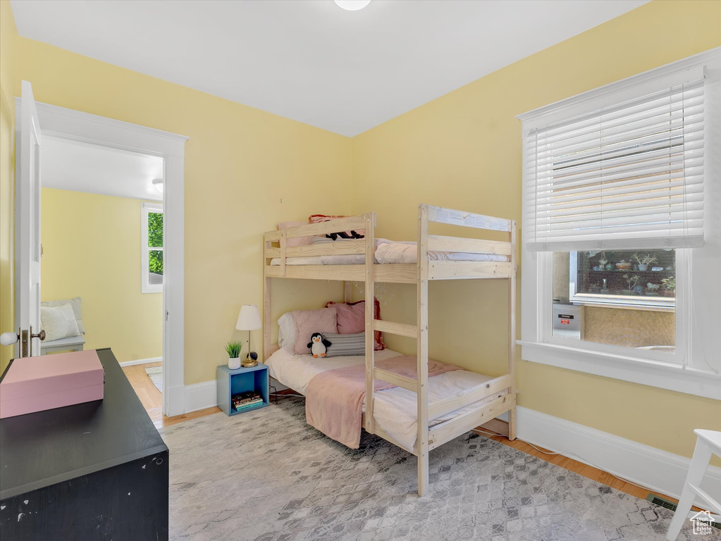 Bedroom with baseboards and wood finished floors