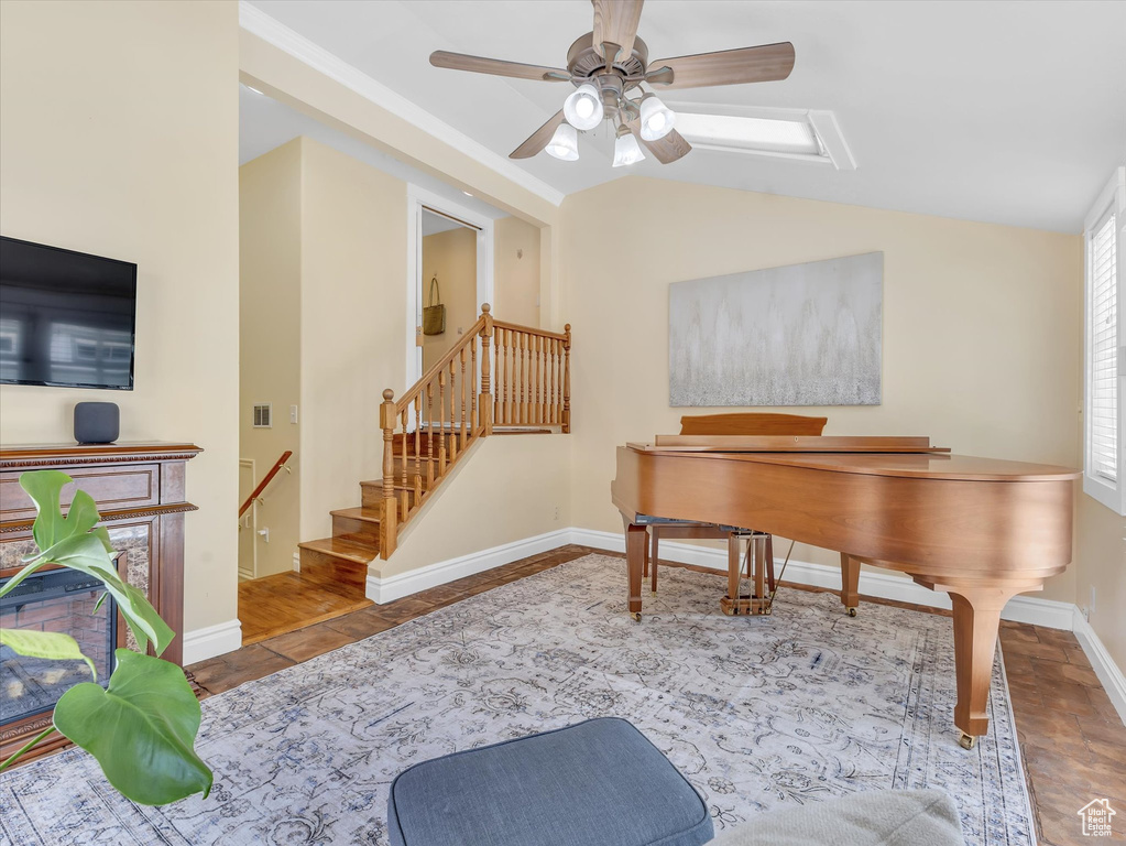 Office area featuring vaulted ceiling, a ceiling fan, and baseboards