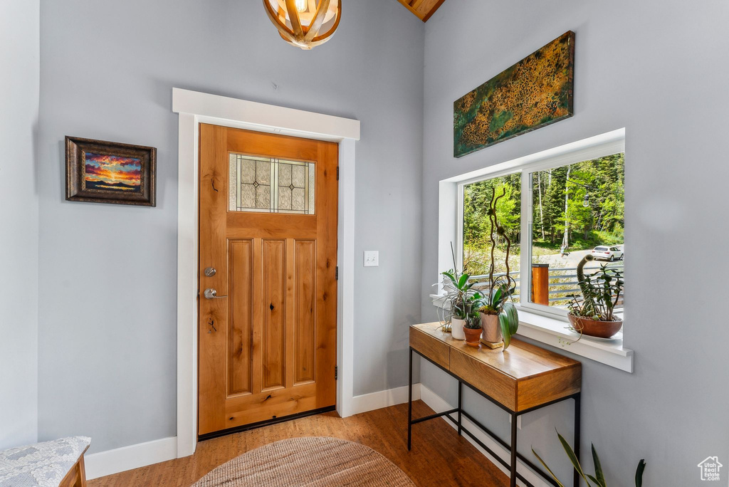 Entrance foyer with baseboards and wood finished floors