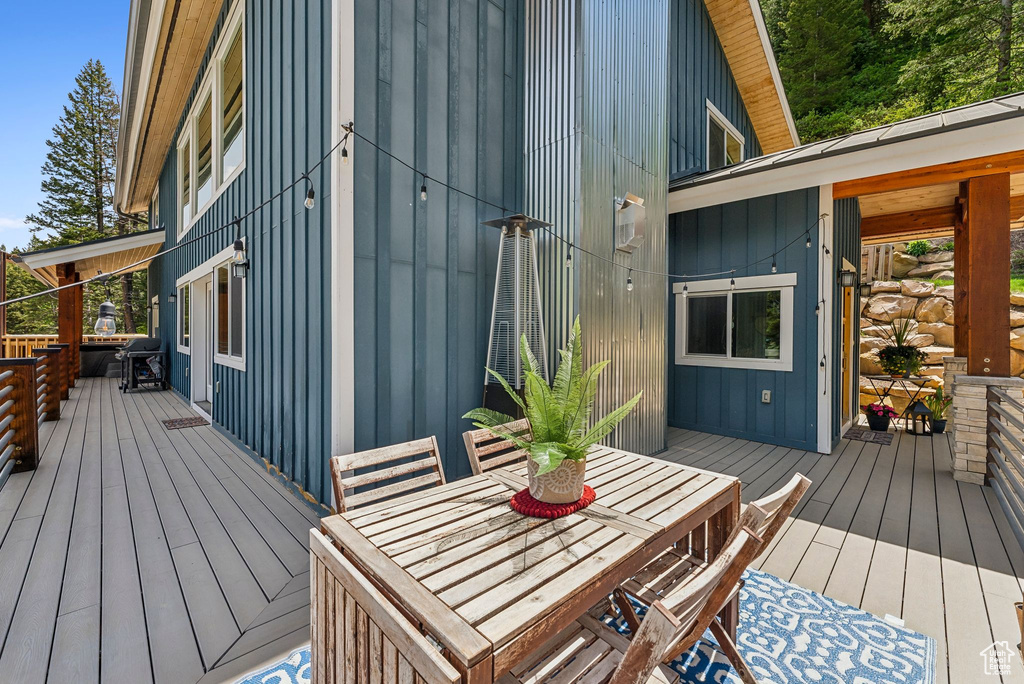 Wooden deck featuring outdoor dining area
