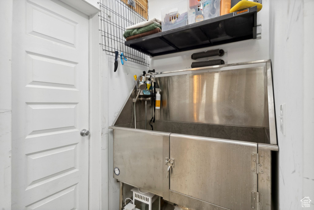 Kitchen view of open shelves and pet washing area
