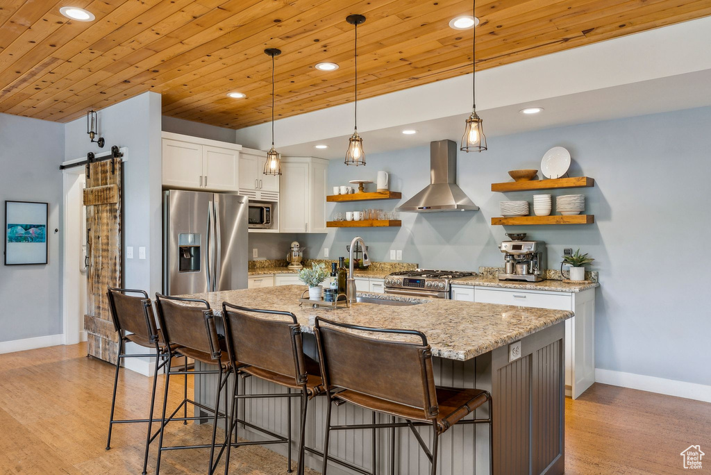Kitchen featuring appliances with stainless steel finishes, wall chimney exhaust hood, open shelves, recessed lighting, and wood ceiling