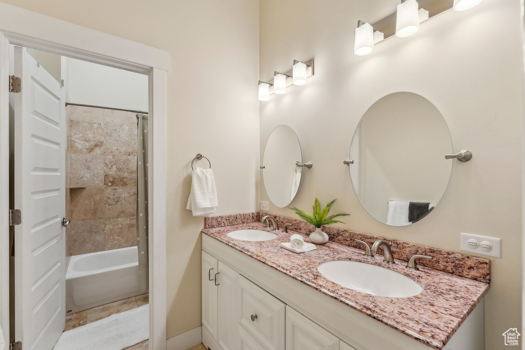 Full bath with double vanity and bathing tub / shower combination