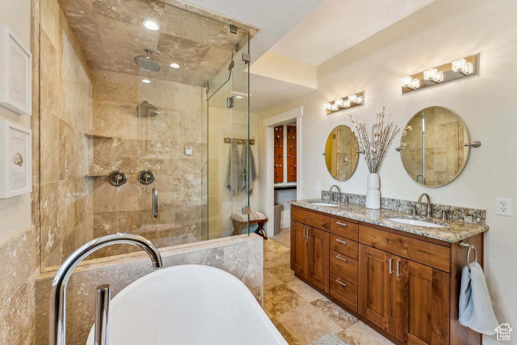 Bathroom with a shower stall, a freestanding bath, and double vanity