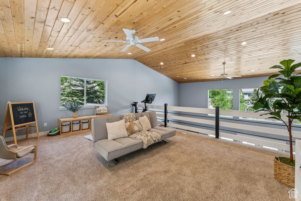 Living area featuring ceiling fan, carpet floors, recessed lighting, vaulted ceiling, and plenty of natural light