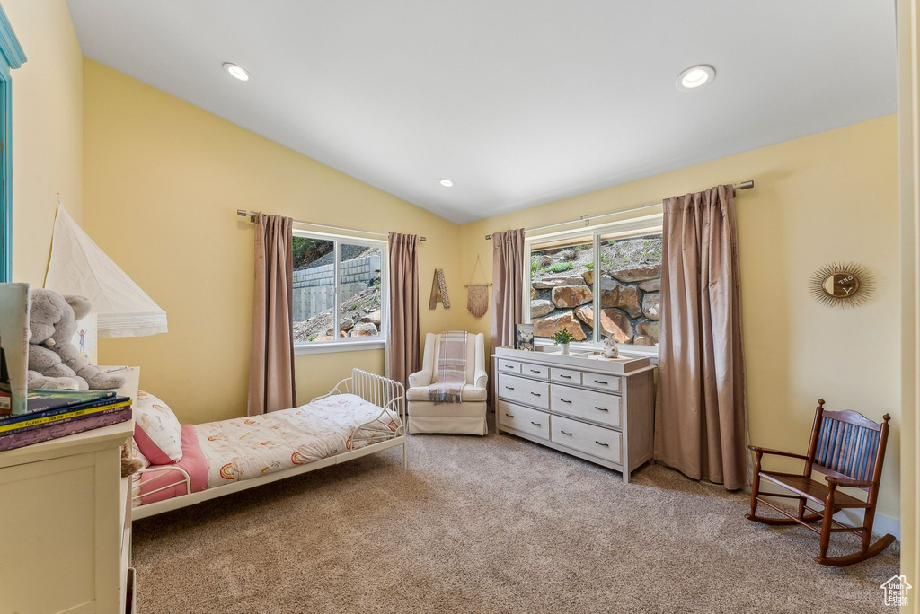 Carpeted bedroom with lofted ceiling and recessed lighting