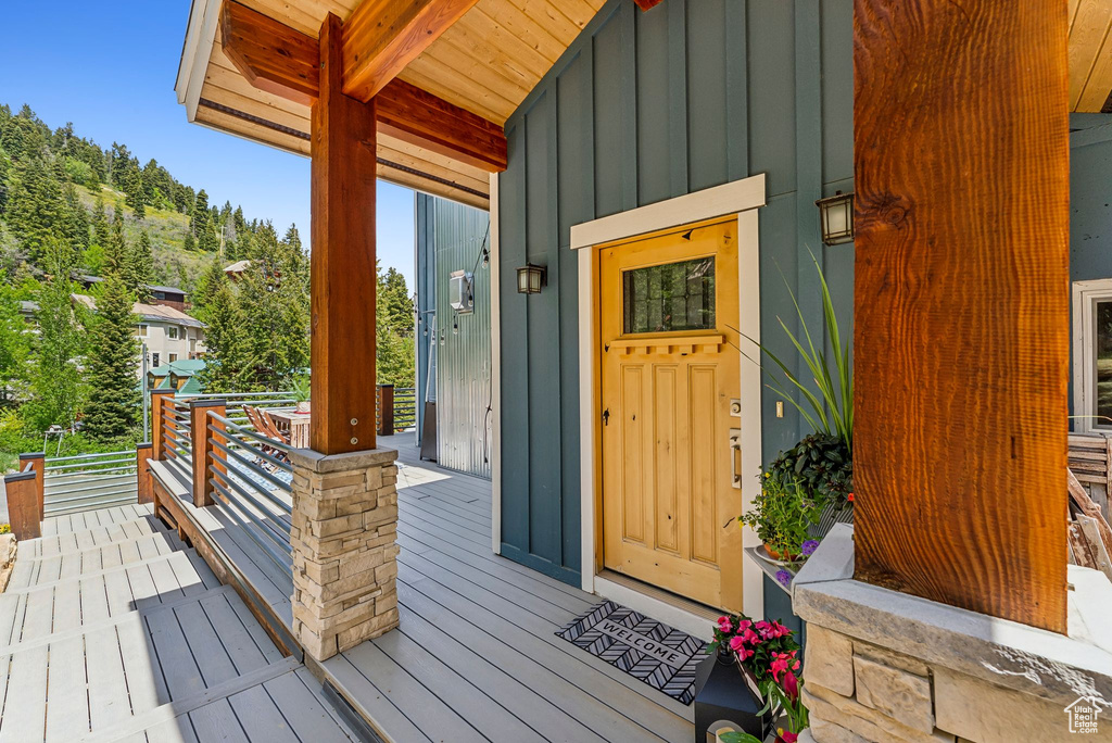 Entrance to property with board and batten siding and covered porch