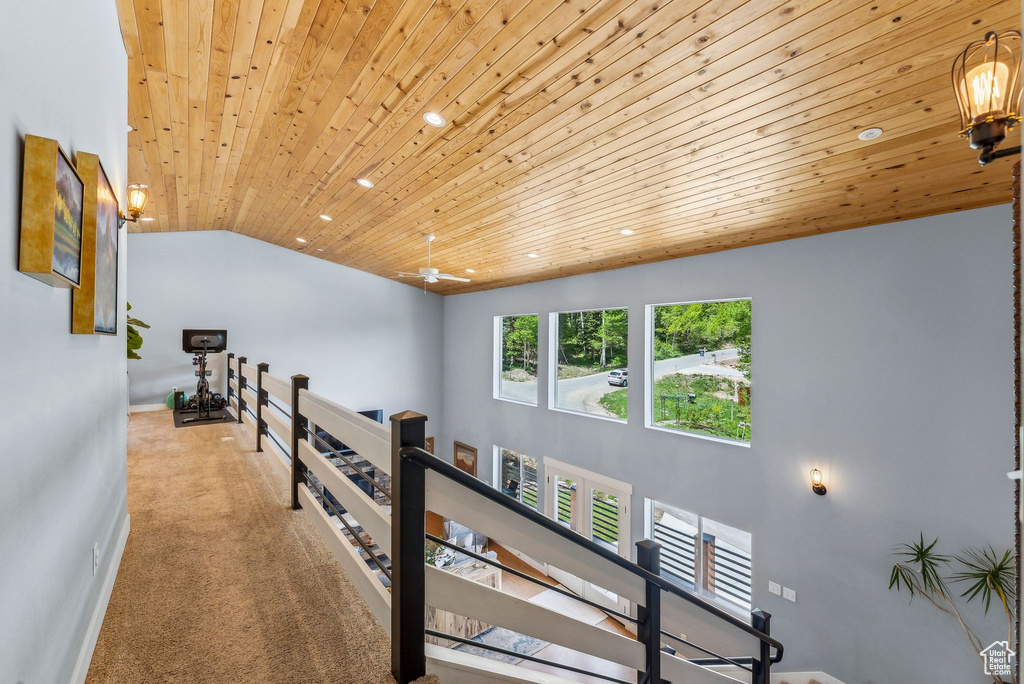 Hall featuring an upstairs landing, wood ceiling, recessed lighting, lofted ceiling, and carpet