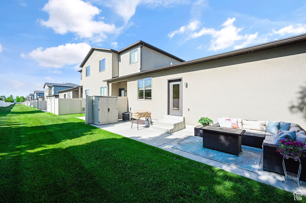 Back of house featuring outdoor lounge area, a patio, stucco siding, and a residential view