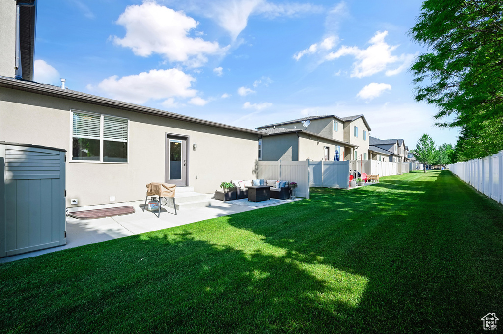 Rear view of house featuring outdoor lounge area, a residential view, stucco siding, and a patio