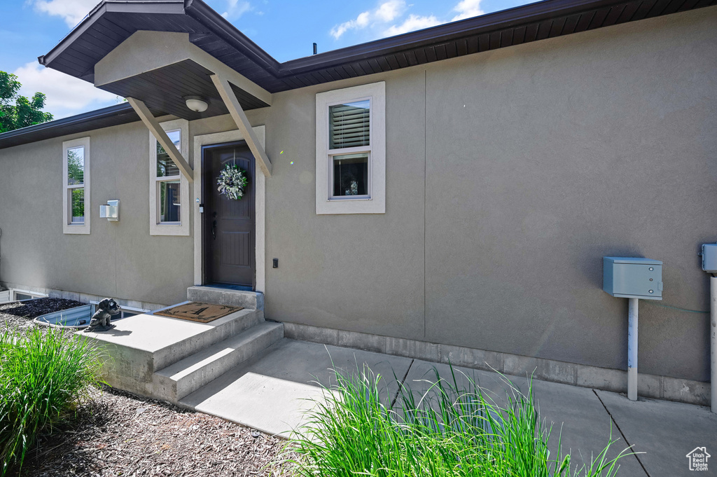 Entrance to property featuring stucco siding