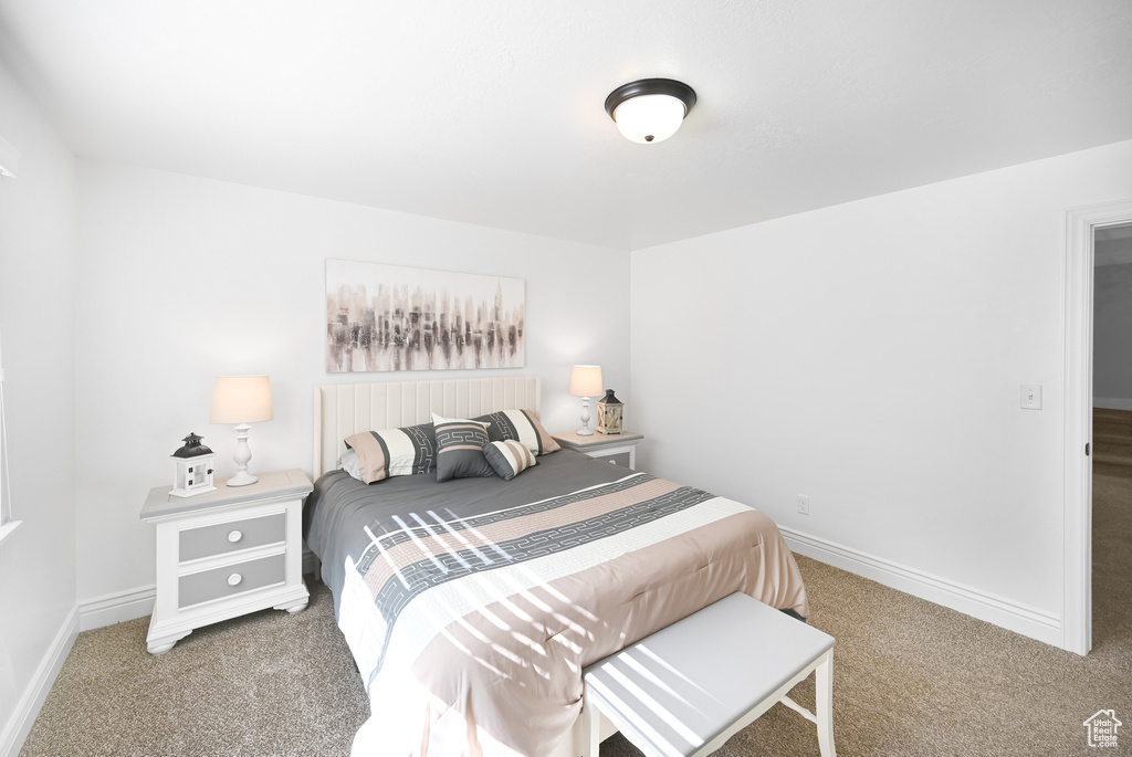 Bedroom featuring carpet flooring and baseboards