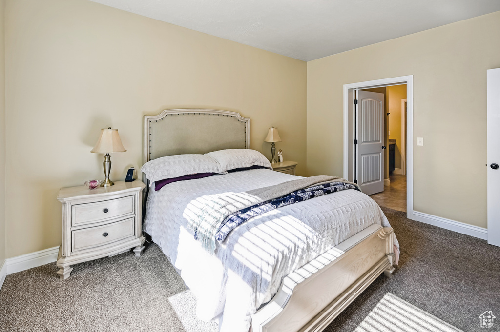 Carpeted bedroom with baseboards
