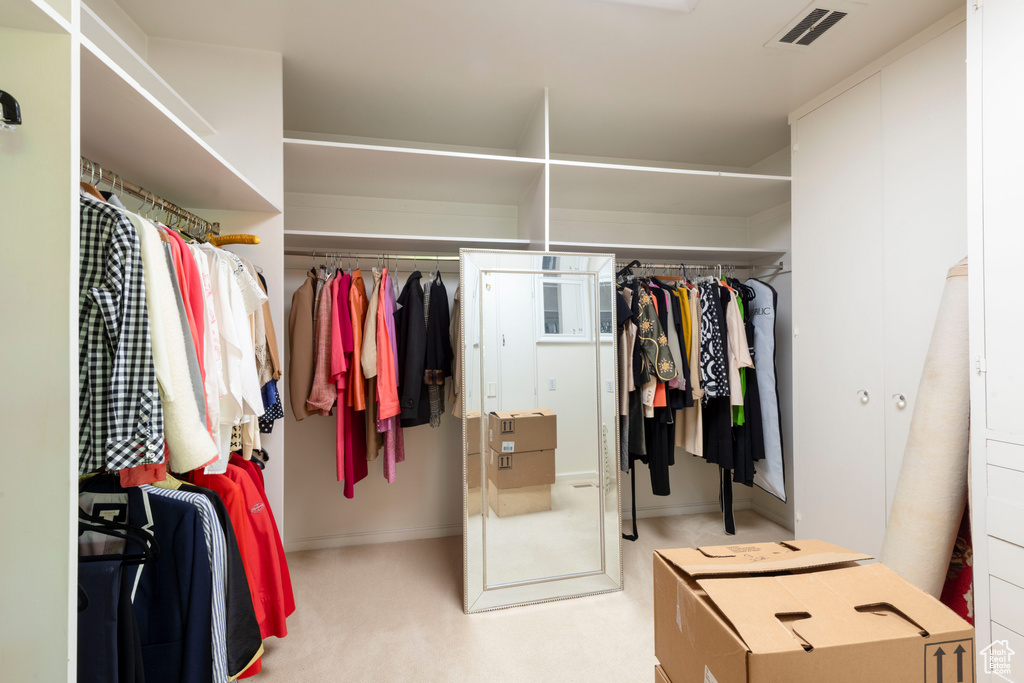 Walk in closet with carpet flooring