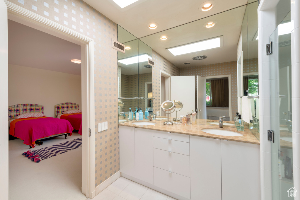 Bathroom featuring wallpapered walls, double vanity, connected bathroom, tile patterned floors, and recessed lighting