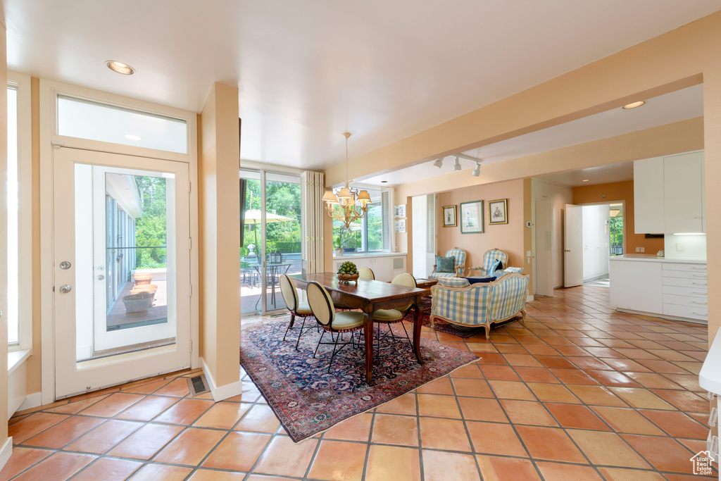 Foyer entrance featuring light tile patterned flooring, healthy amount of natural light, a chandelier, and recessed lighting