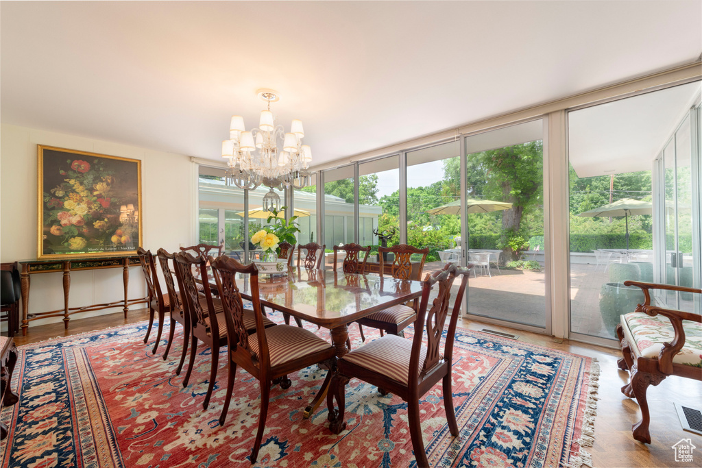 Dining room with a chandelier, plenty of natural light, and floor to ceiling windows