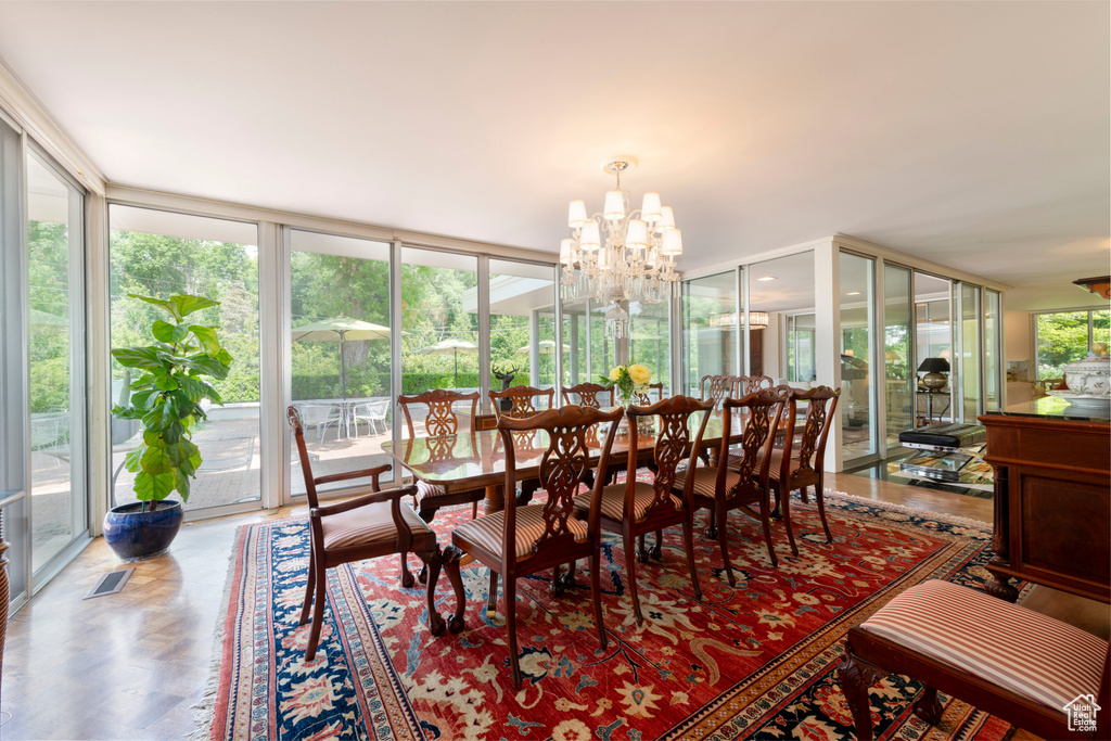 Dining room with expansive windows and a chandelier