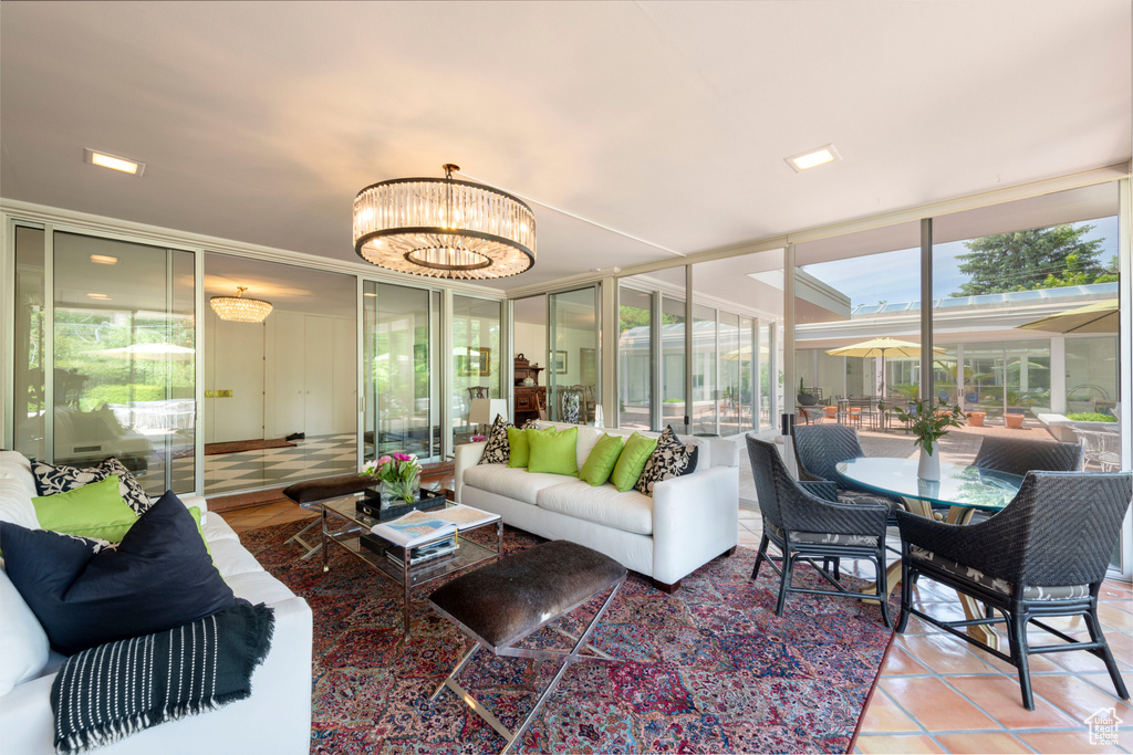Sunroom / solarium featuring plenty of natural light and a chandelier